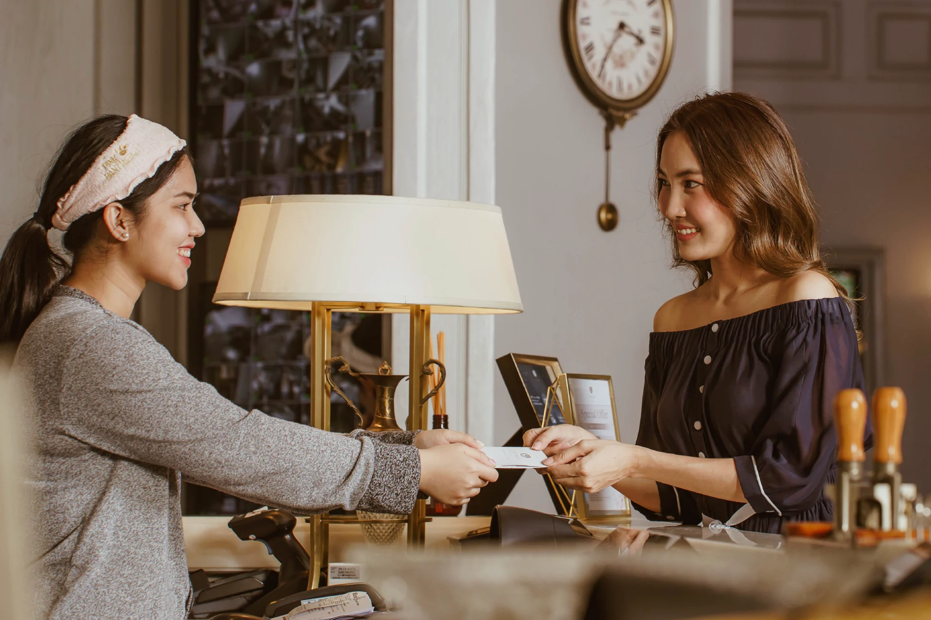 Guest speaking with hotel front desk staff during flexible 25-hour stay check-in in Sukhumvit Bangkok