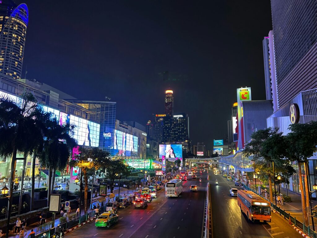 CentralWorld Bangkok night view at Ratchaprasong intersection with traffic, city lights, and busy shopping district
